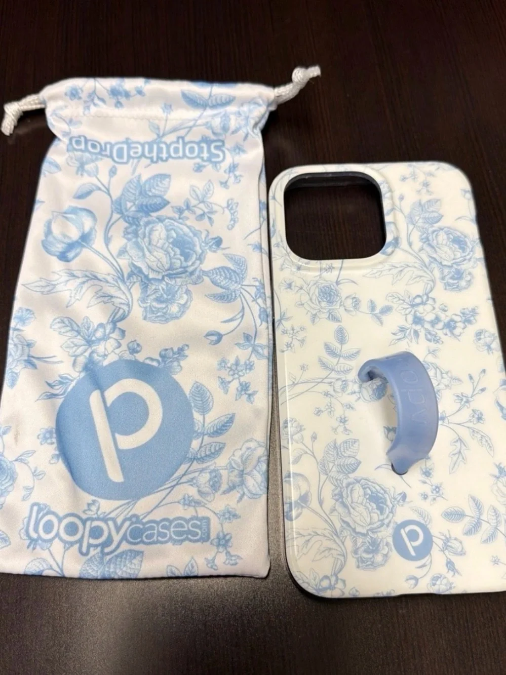 Lightly Used Loopy IPhone 15 Promax case in blue toile.